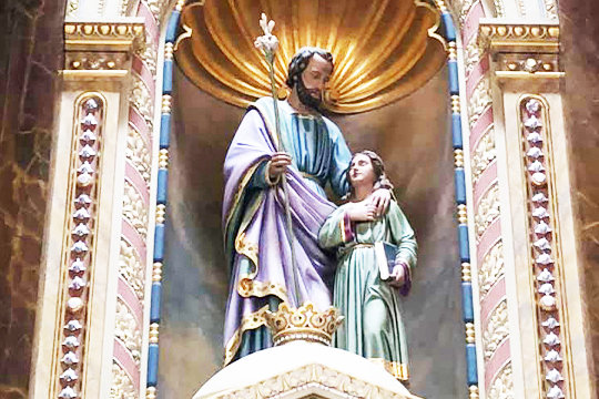 This image of St. Joseph and the child Jesus adorns the reredos above the Altar of Answered Prayers in the Shrine of St. Joseph in St. Louis.